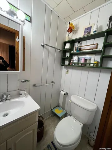 a bathroom with a sink a toilet and shower curtain