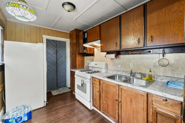 a kitchen with stainless steel appliances granite countertop a sink stove and cabinets