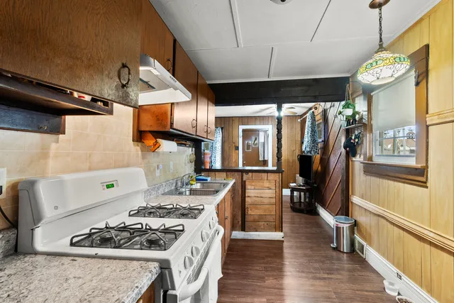 a kitchen with stainless steel appliances granite countertop a stove and a refrigerator