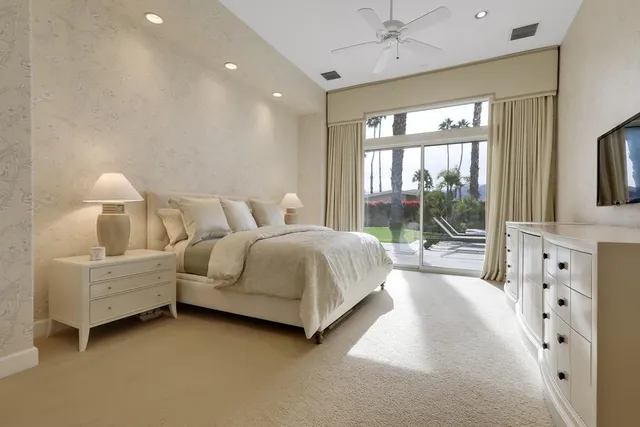 a bedroom with a bed and a large window