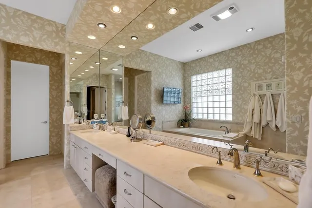 a bathroom with double vanity sinks double vanity and a mirror