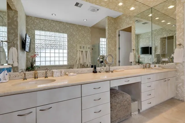 a bathroom with double sink and a mirror