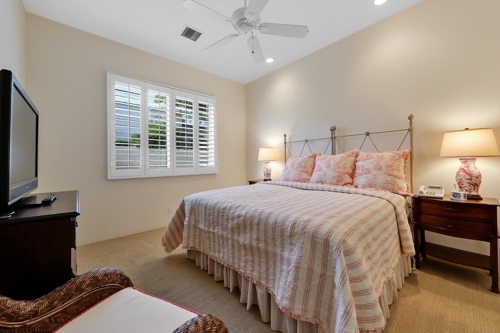 70955 Sunny Lane Rancho Mirage, CA 92270 - Photo 19 of 35 a bedroom with a bed and a flat tv screen on dresser