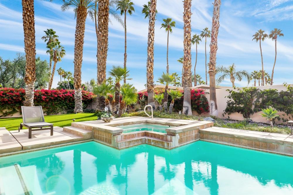 70955 Sunny Lane Rancho Mirage, CA 92270 - Photo 25 of 35 a view of a swimming pool with a lawn chairs and a lawn chairs