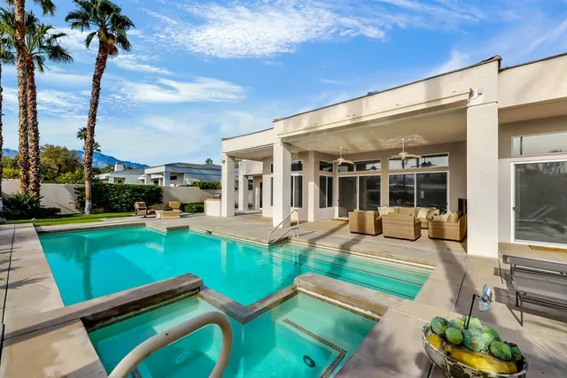 a front view of a house with garden and patio