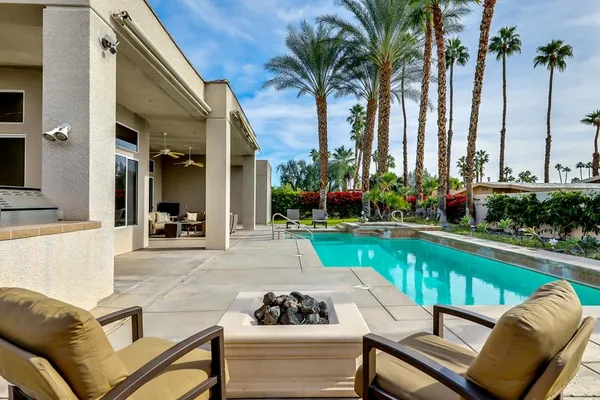 a view of swimming pool with outdoor seating and plants