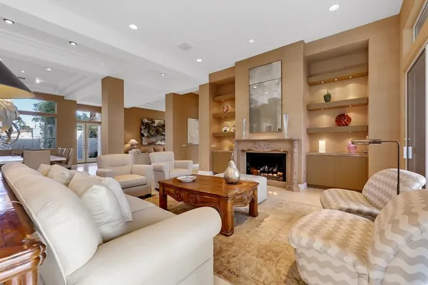 a living room with furniture large window and a fireplace