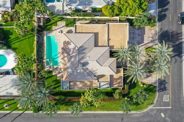 an aerial view of a house with a yard and potted plants