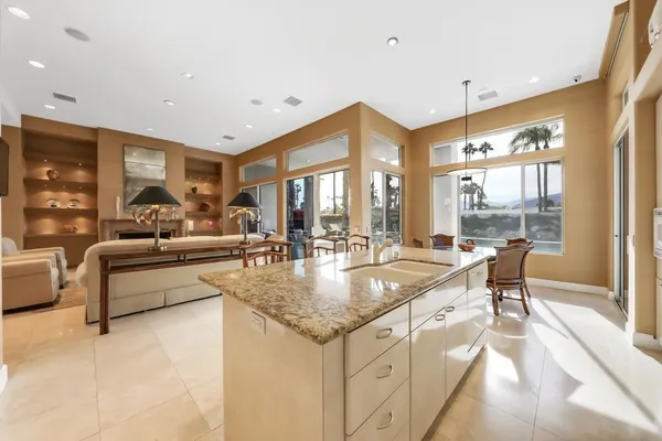 a dining hall with stainless steel appliances granite countertop a granite counter tops and a view of living room
