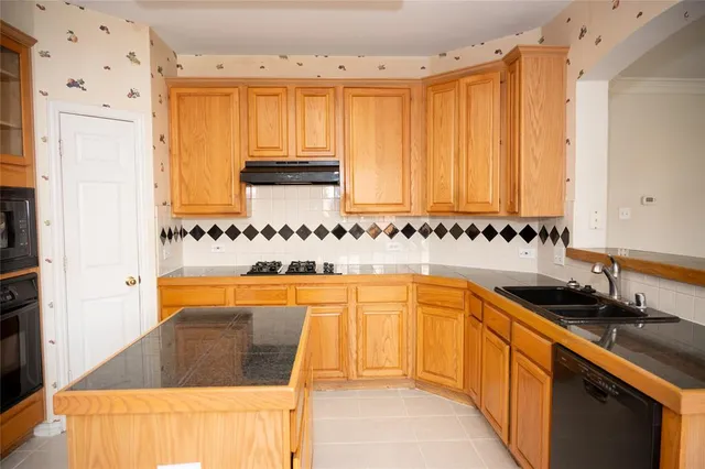 a kitchen with stainless steel appliances granite countertop a sink and cabinets