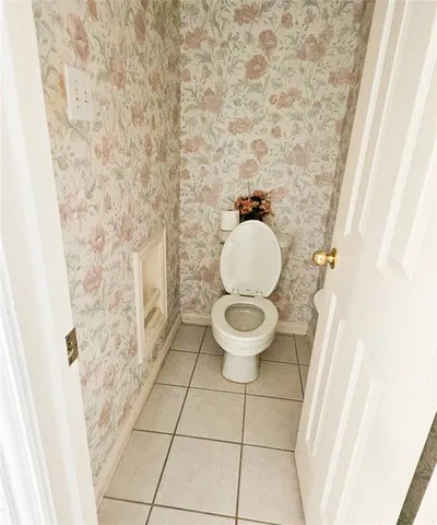 a bathroom with a toilet and a shower curtain