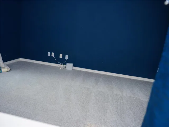 an empty room with wooden floor and a window