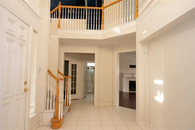 a view of backyard with potted plants and wooden fence