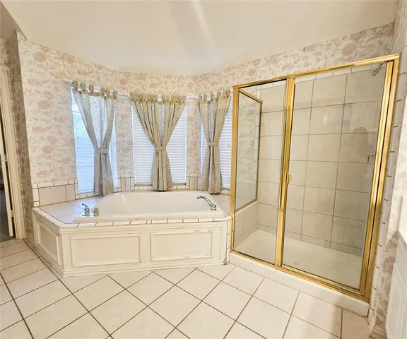 a white bath tub sitting next to a white sink