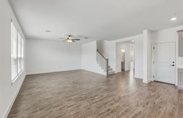 a large white kitchen with a large counter top appliances and cabinets