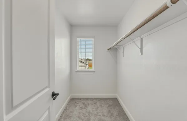 a view of an empty room with a fan