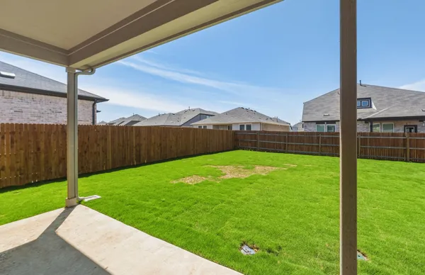 a view of a house with a yard and a garden