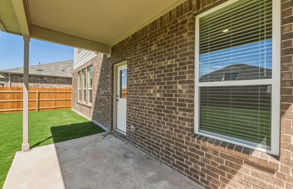 a view of green field with a small yard