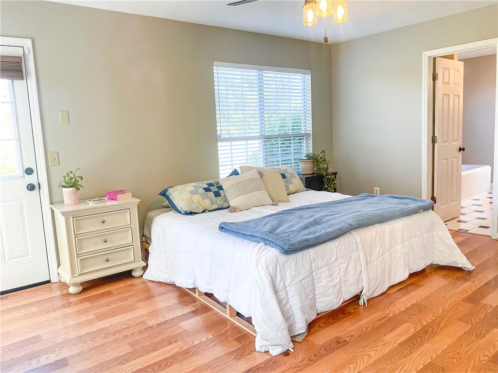 280 Mimosa Road Phenix City, AL 36870 - Photo 11 of 38 Bedroom featuring light wood-style flooring, ceiling fan, and ensuite bathroom