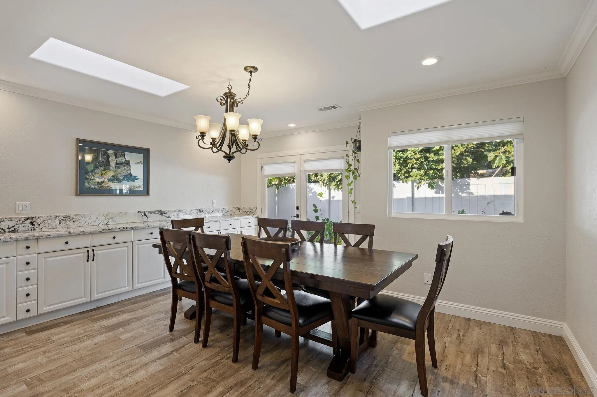 14433 Range Park Road Poway, CA 92064 - Photo 17 of 46 a view of a dining room with furniture a chandelier and wooden floor