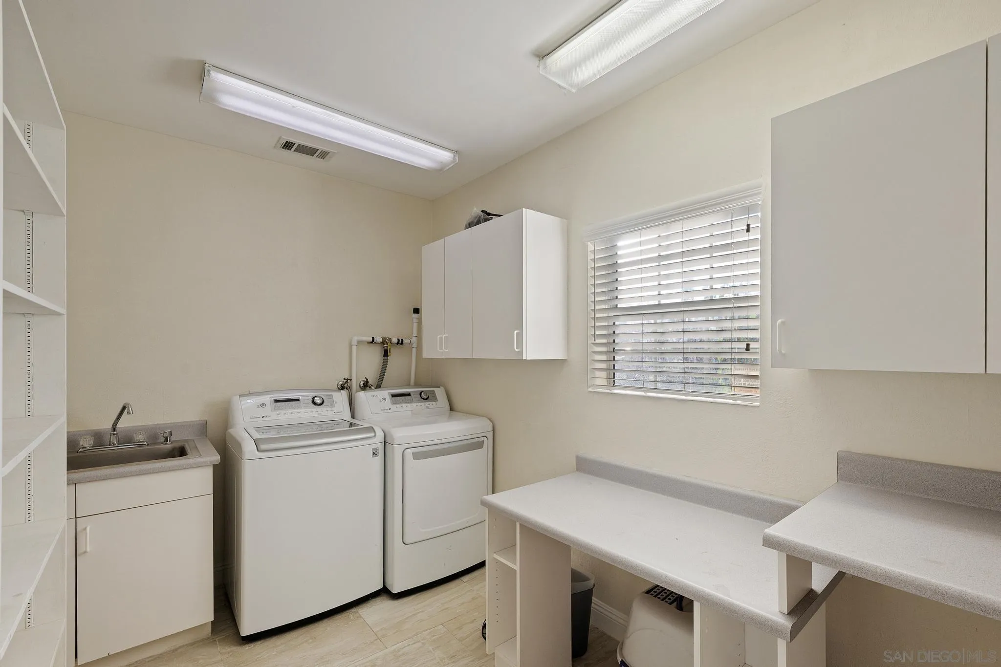 14433 Range Park Road Poway, CA 92064 - Photo 34 of 46 a utility room with dryer and washer