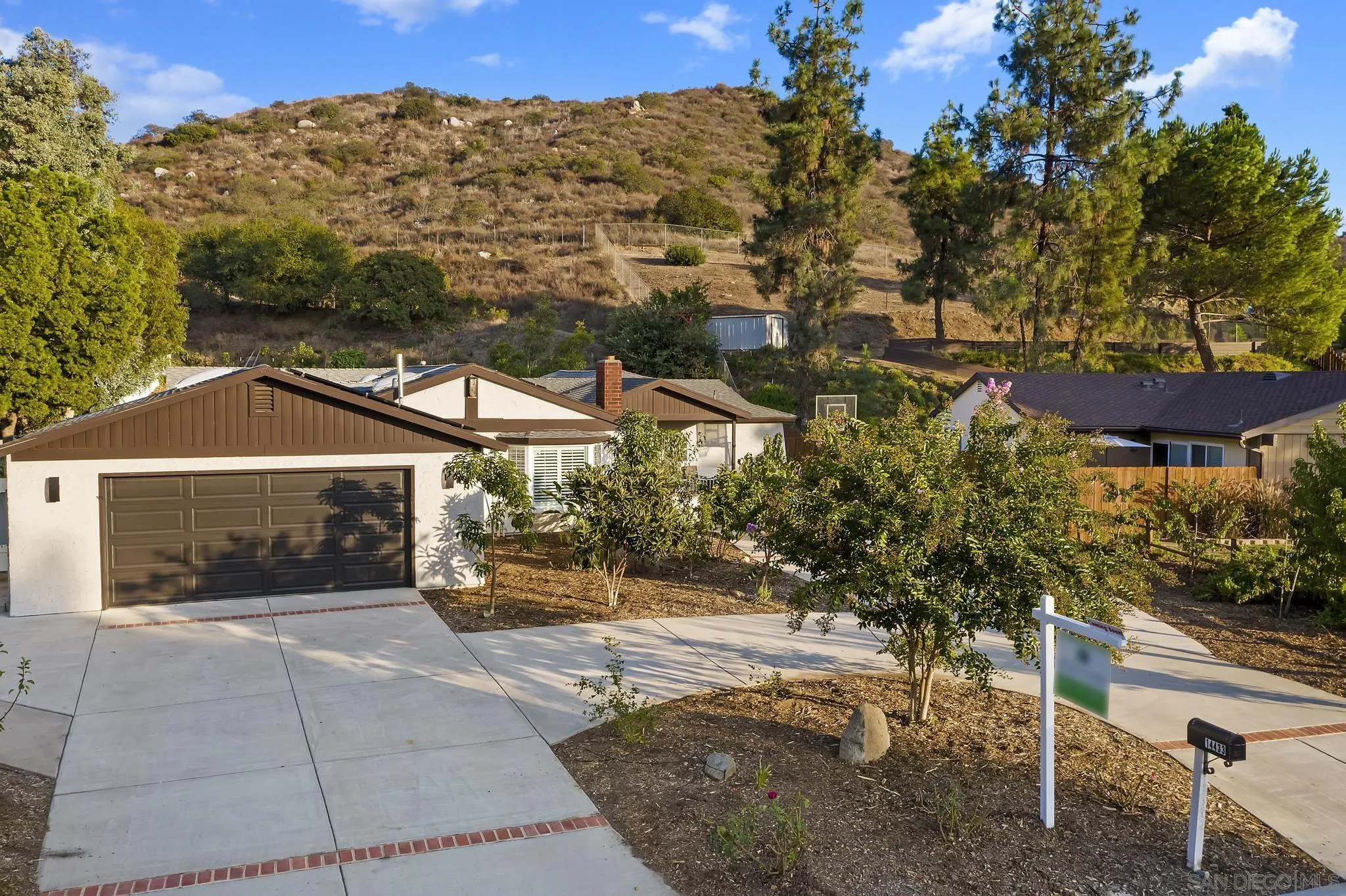 14433 Range Park Road Poway, CA 92064 - Photo 41 of 46 a view of a patio with a table and chairs under an umbrella