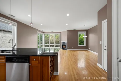 a view of a kitchen with granite countertop a refrigerator and a sink