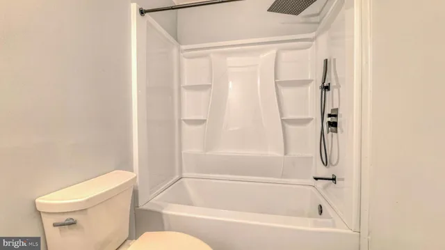 a bathroom with a toilet and a bathtub