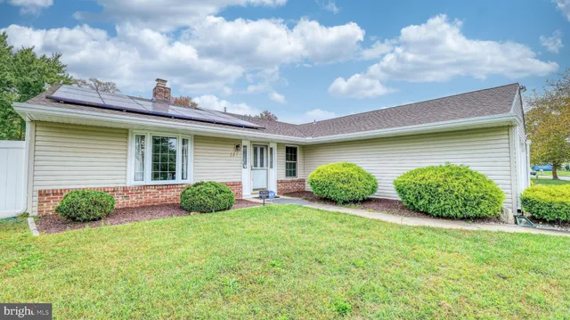 a front view of house with yard and green space