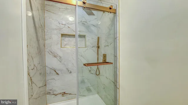 a bathroom with a glass shower door