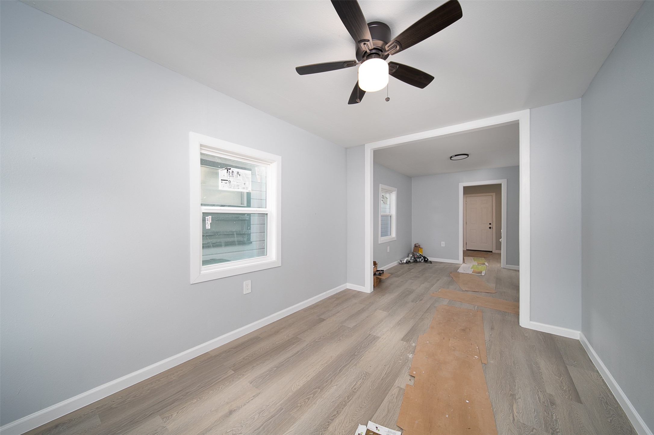 3120 Stonewall Street Houston, TX 77020 - Photo 11 of 18 wooden floor in an empty room with a window