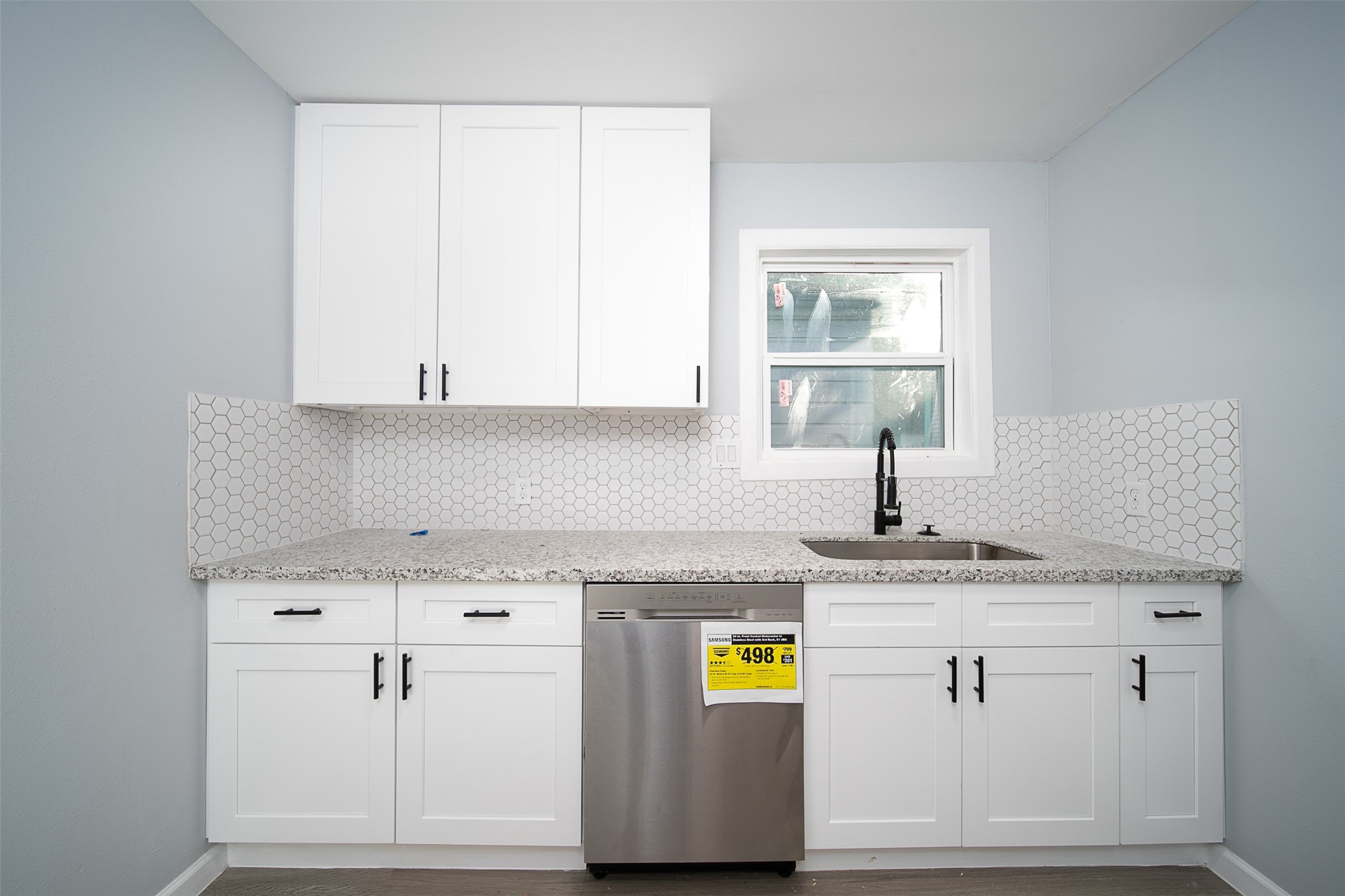3120 Stonewall Street Houston, TX 77020 - Photo 14 of 18 a kitchen with a white cabinets sink and stove