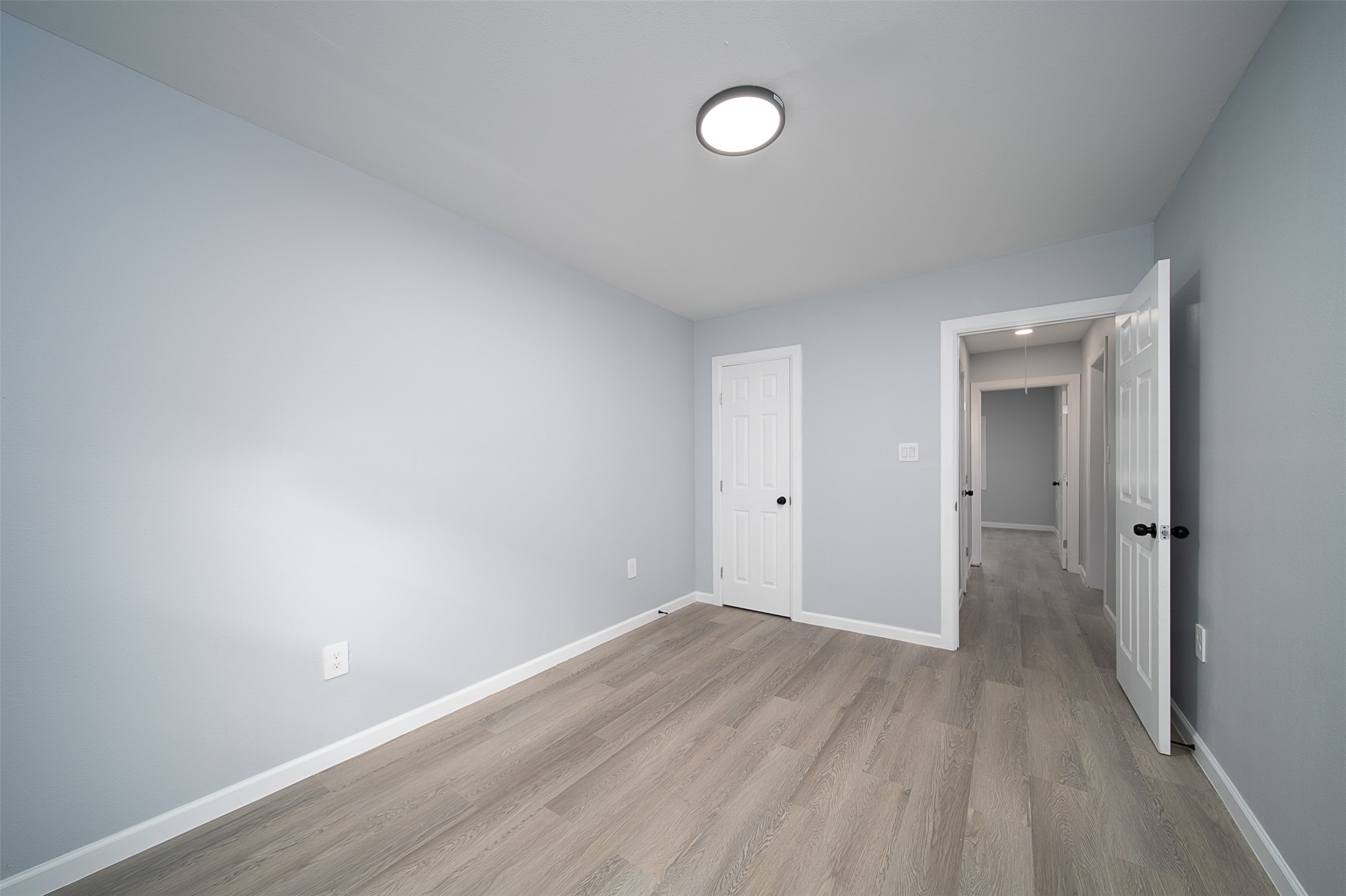3120 Stonewall Street Houston, TX 77020 - Photo 5 of 18 a view of an empty room with wooden floor and a window