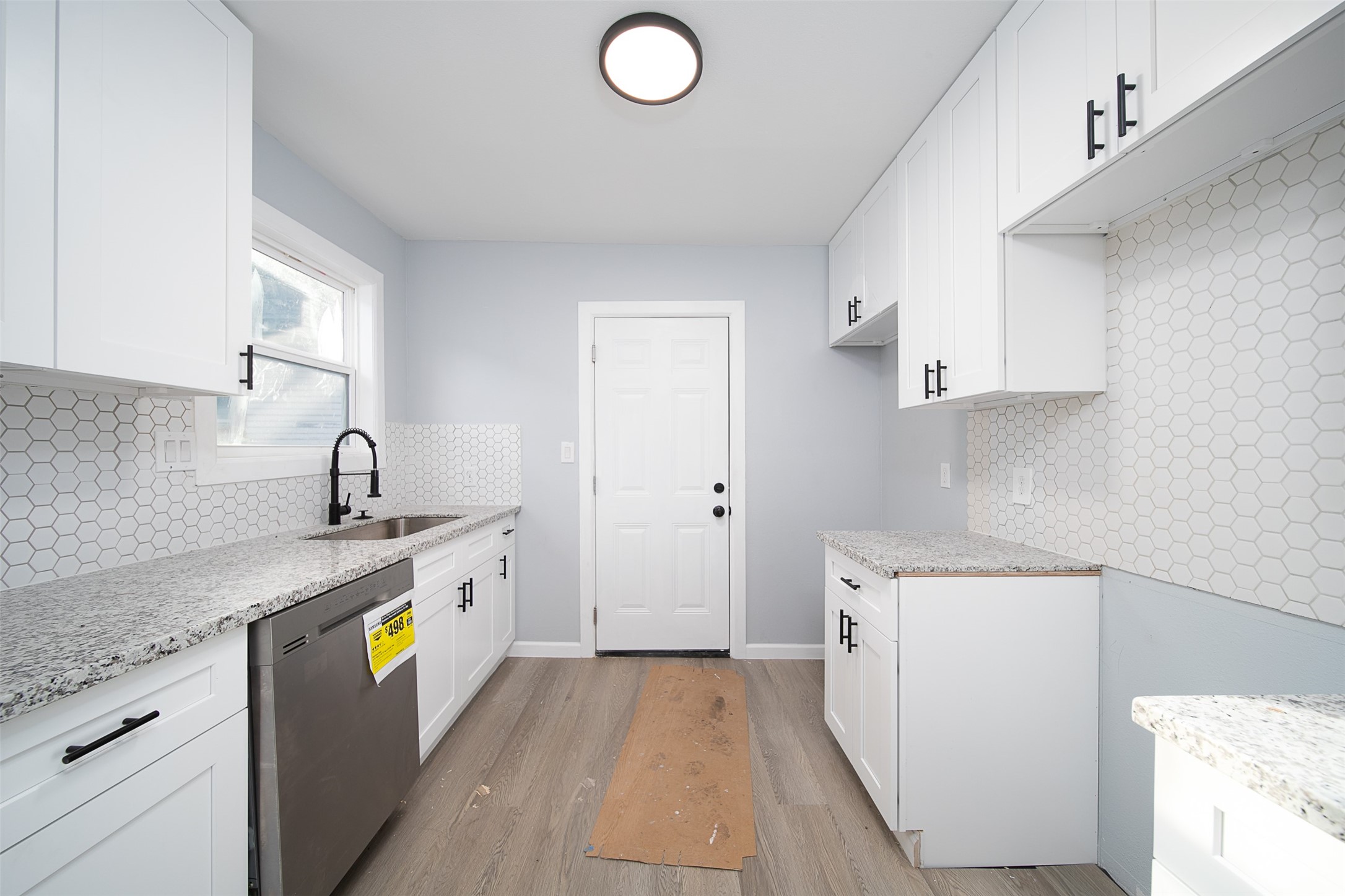 3120 Stonewall Street Houston, TX 77020 - Photo 8 of 18 a kitchen with a sink a stove and cabinets