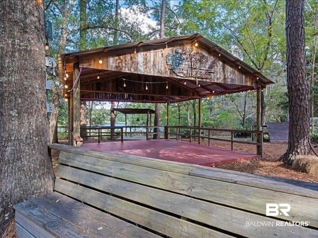 4650 Wiggins Lane Wilmer, AL 36587 - Photo 43 of 66 View of community featuring a wooden deck and a gazebo