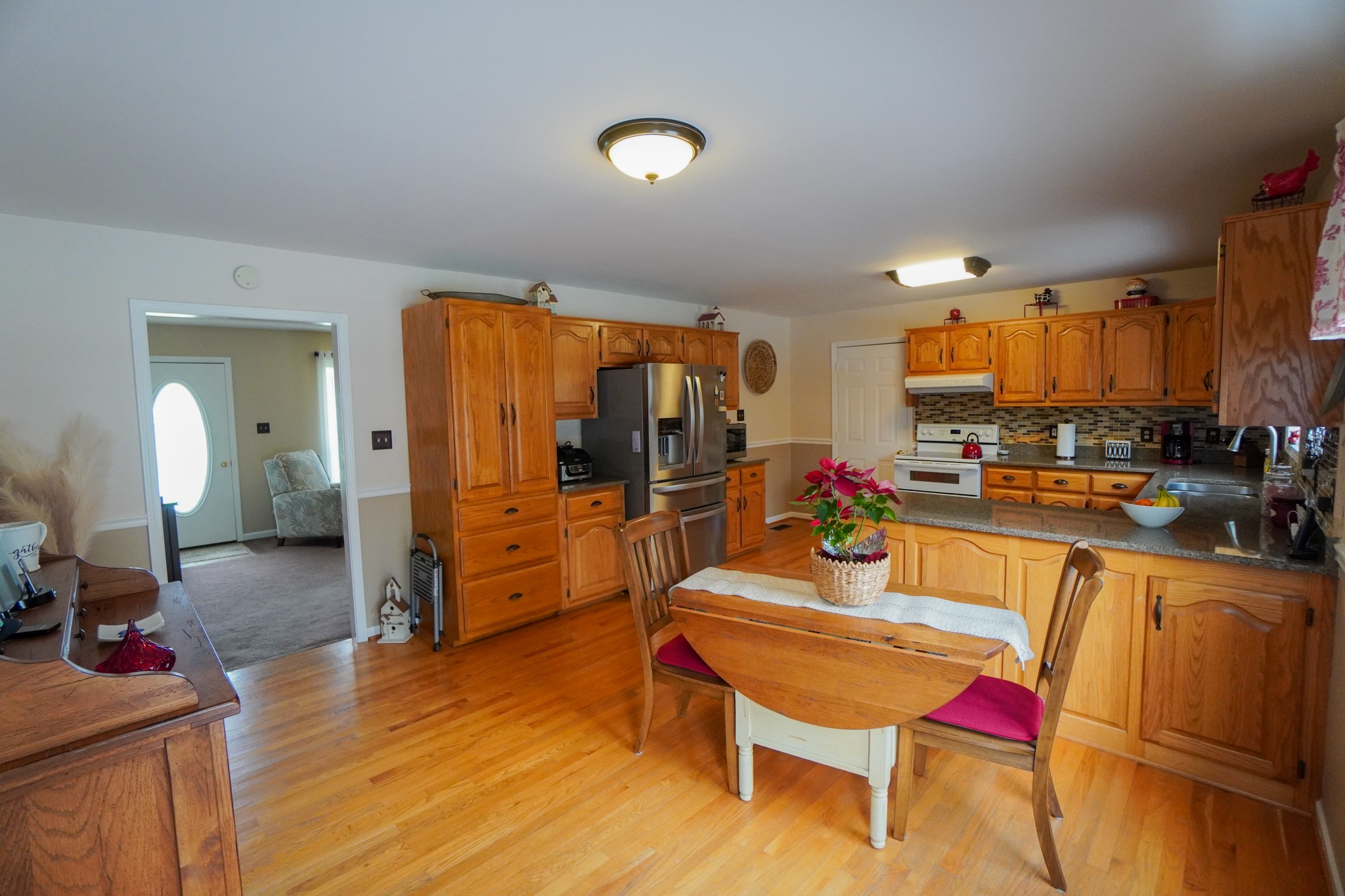 1890 Clara Mathis Road Spring Hill, TN 37174 - Photo 20 of 45 a living room with stainless steel appliances furniture a rug kitchen view and a chandelier
