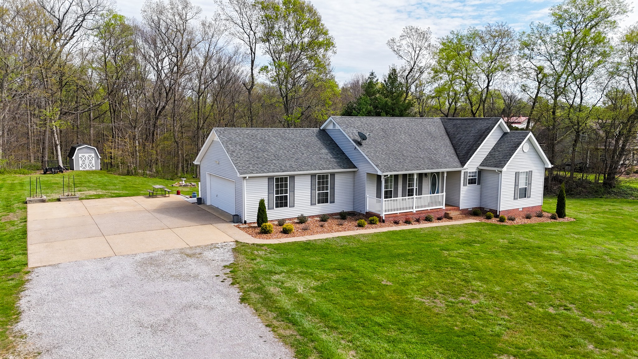 1890 Clara Mathis Road Spring Hill, TN 37174 - Photo 2 of 45 a view of house with garden and tall trees
