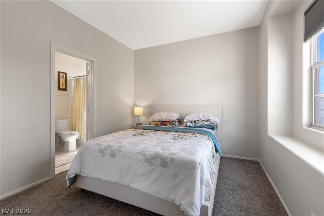 2377 Ramsgate Drive Henderson, NV 89074 - Photo 18 of 25 A well-lit bedroom provides direct access to a functional bathroom.