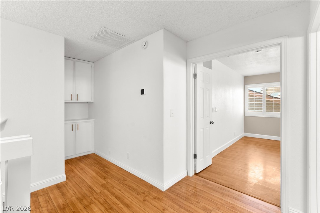 4430 Cranbrook Way Las Vegas, NV 89103 - Photo 33 of 50 Hardwood floors flow through this light-filled room, featuring convenient built-in storage and a bright window.