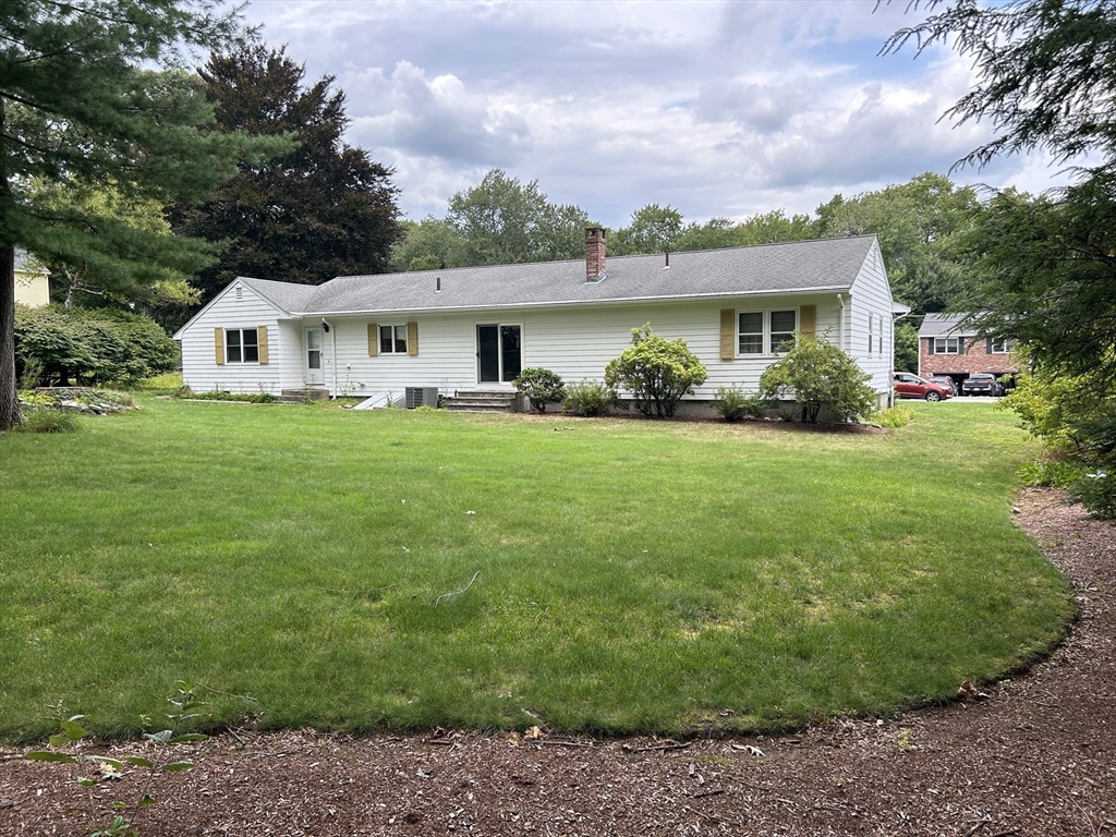 67 Spruce Road Reading, MA 01867 - Photo 3 of 4 a front view of a house with garden