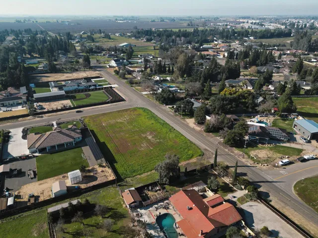 an aerial view of a houses with a yard
