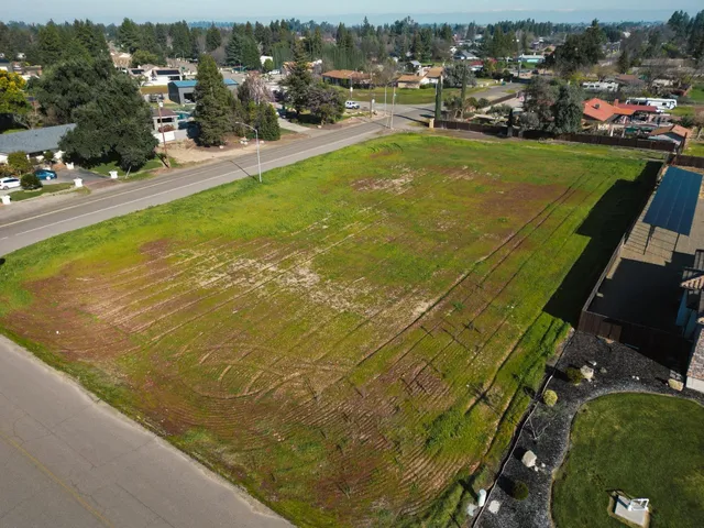 an aerial view of a house with a swimming pool and lake view