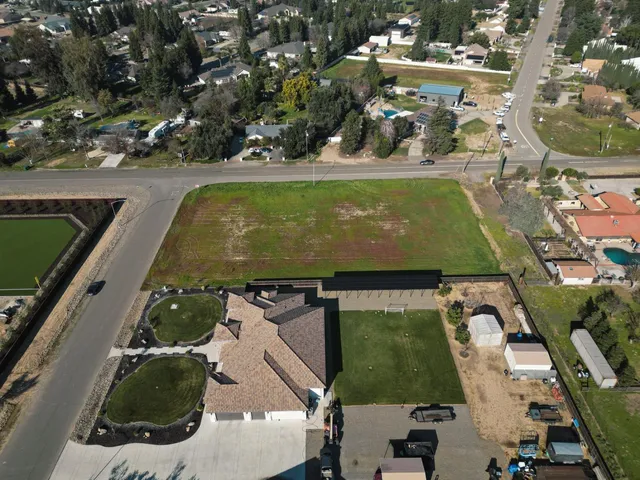 an aerial view of a residential houses with outdoor space