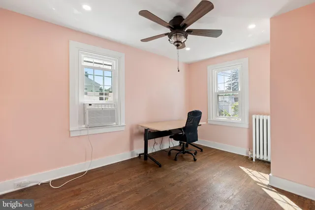a view of a workspace with furniture and a window