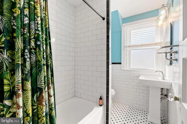 a bathroom with a shower and a sink