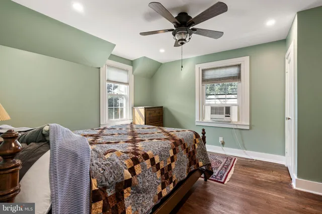 a bedroom with a bed a window and a chandelier