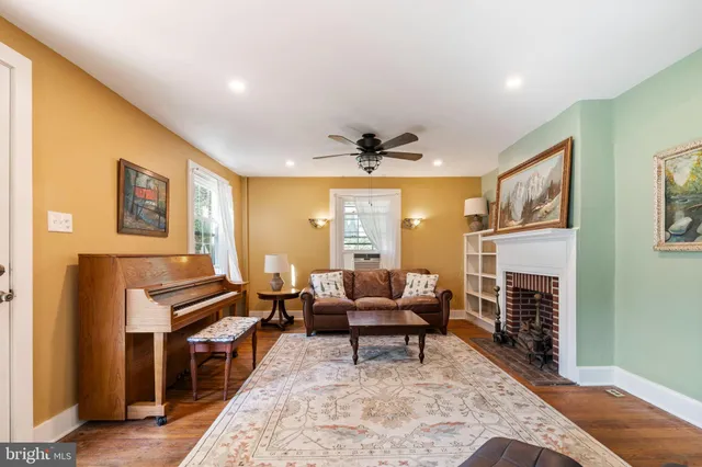 a living room with fireplace furniture and a flat screen tv