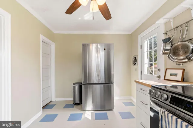 a kitchen with granite countertop a refrigerator a stove and a sink
