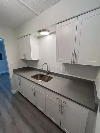 a kitchen with stainless steel appliances granite countertop a sink and a stove