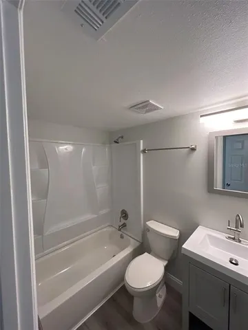 a bathroom with a sink toilet a mirror and shower